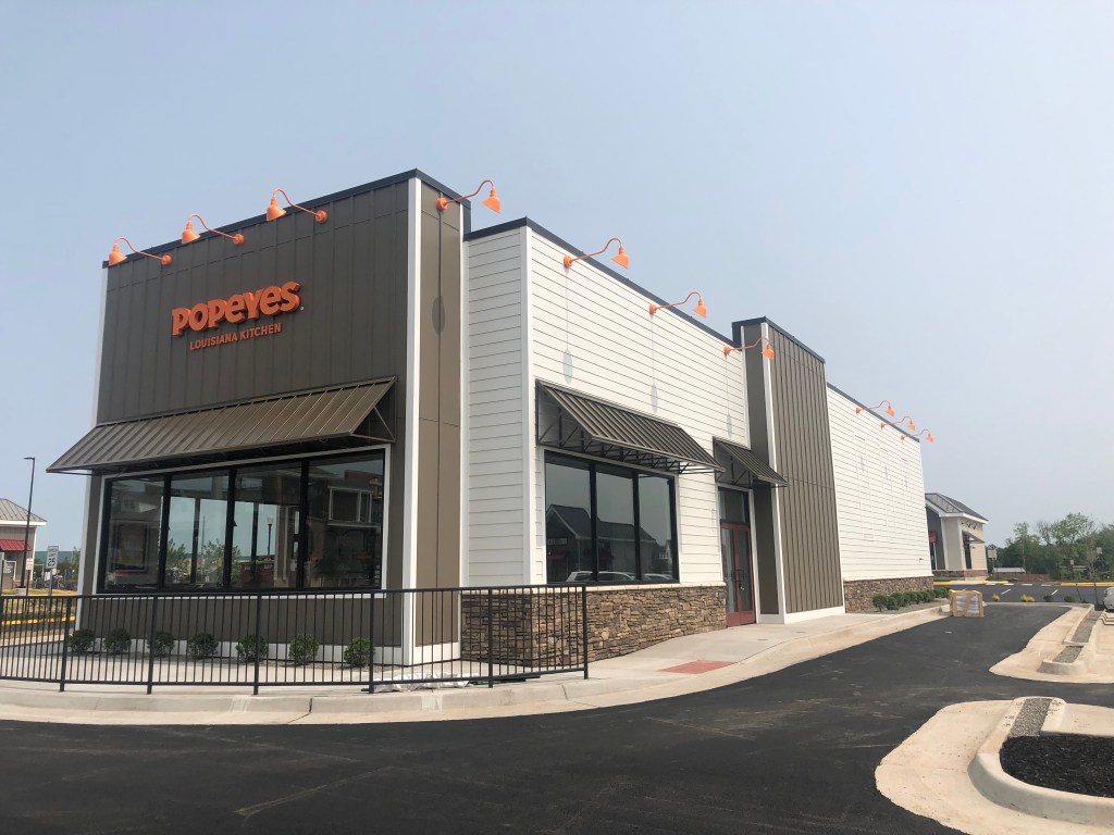Exterior of a Popeyes restaurant design.