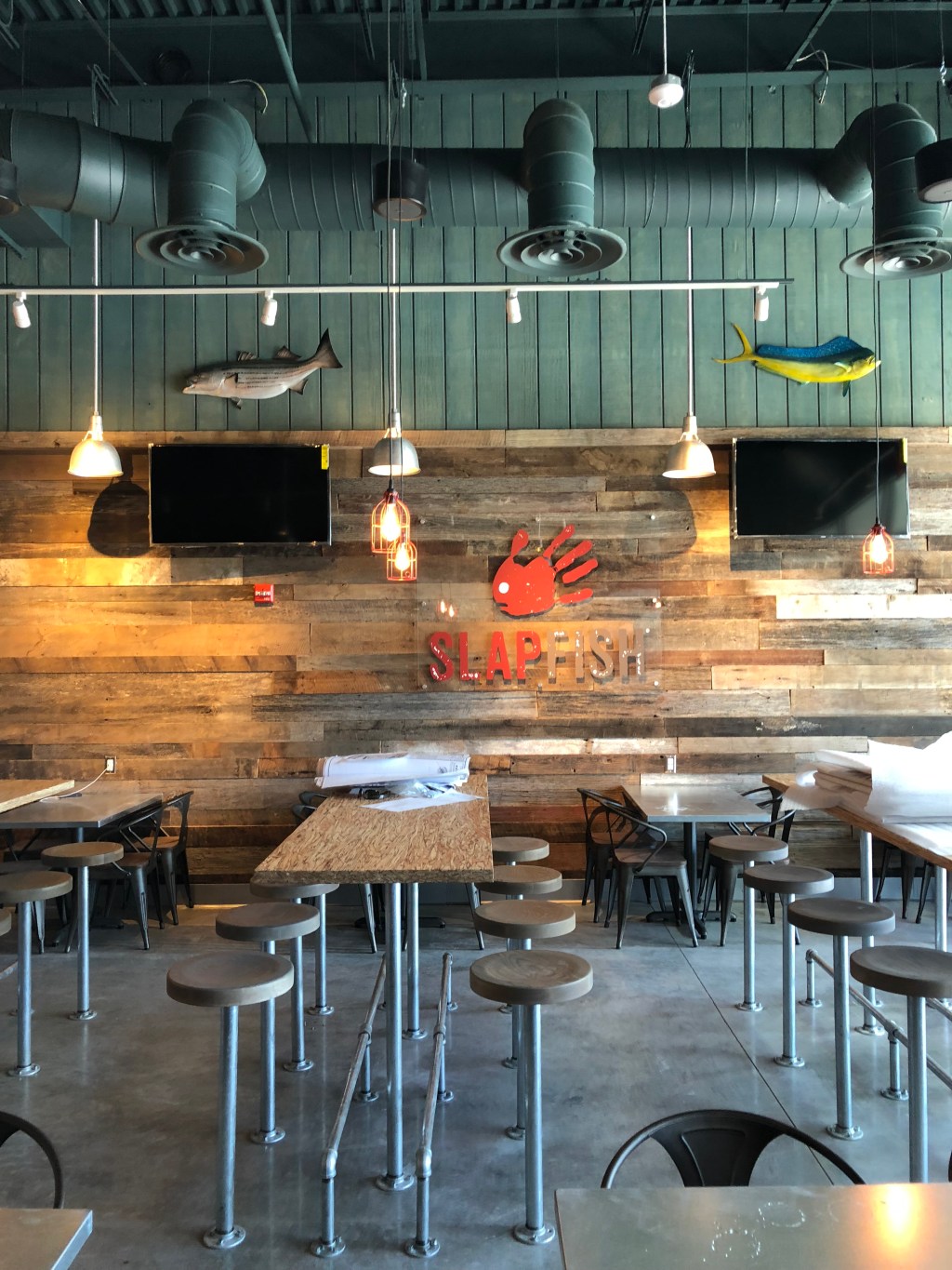 Interior design of the dining room of a Slapfish restaurant.